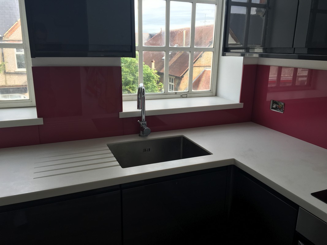 Deep plum coloured glass splashback in modern Norbury kitchen