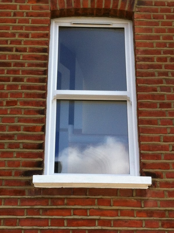 uPVC sash window on Victorian red brick house in Norbury